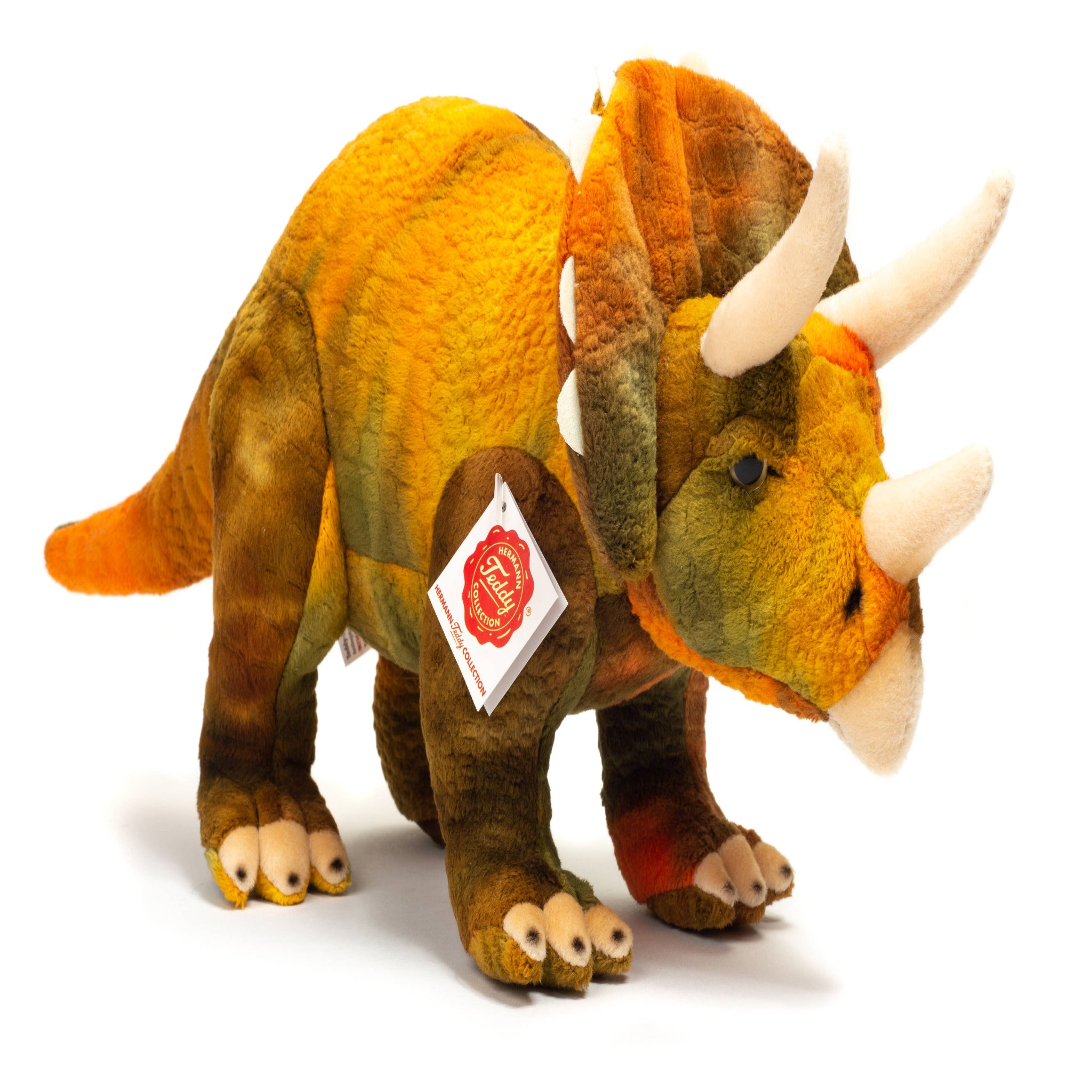 Plush triceratops toy with a visible brand tag on a white background