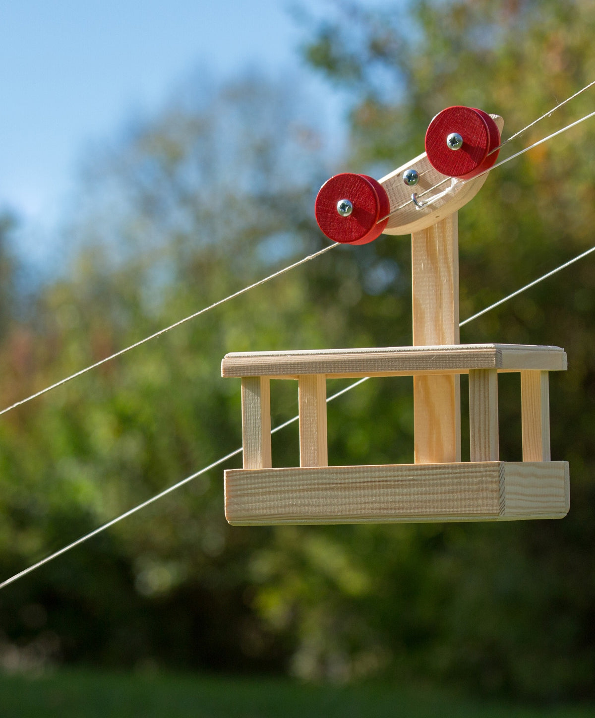 Big Cable Car Kit by Kraul, the gondola on its rope in a garden