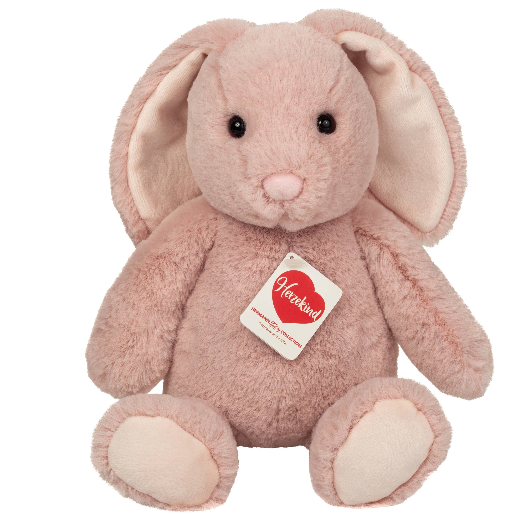 Pink plush bunny with a Heartland tag on a white background