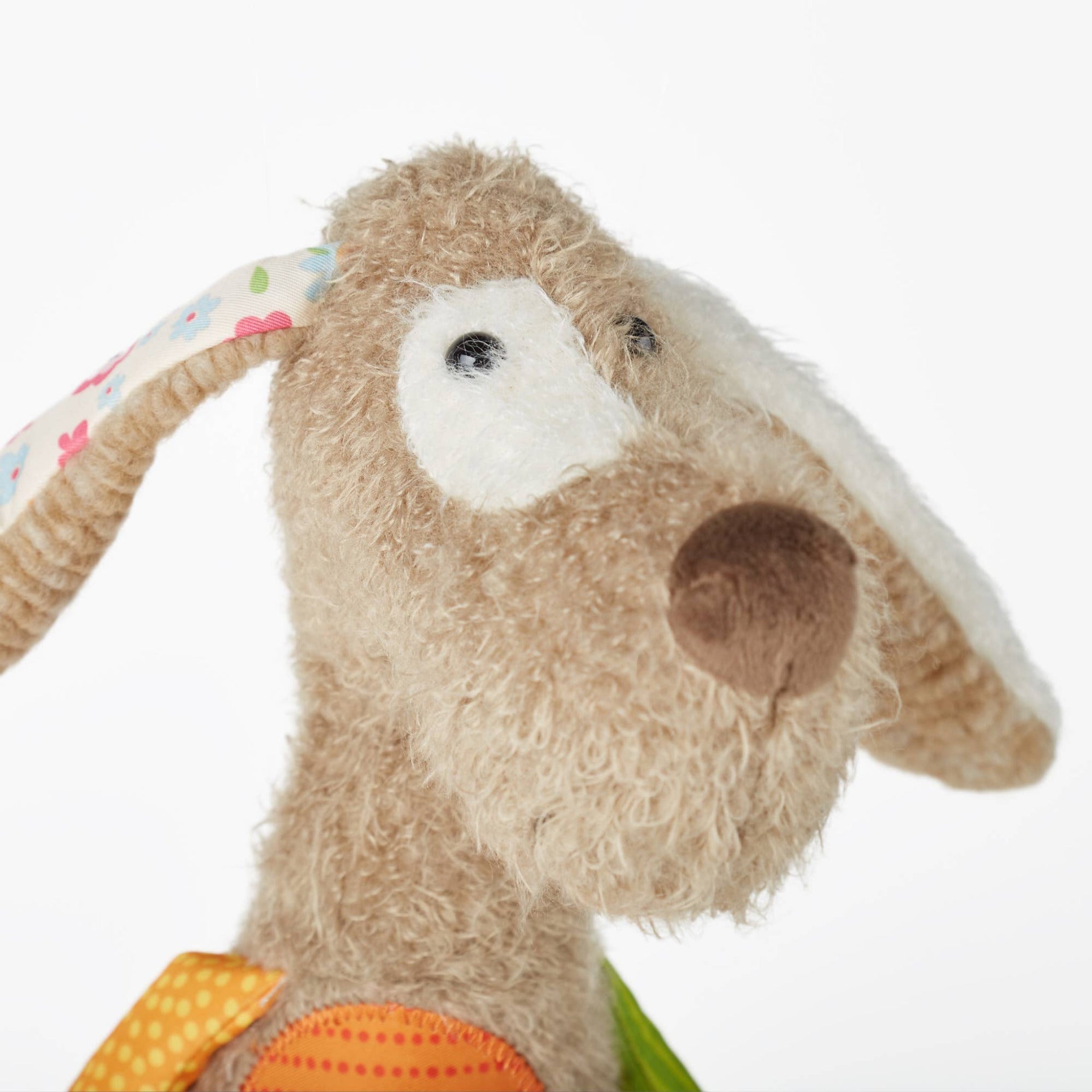 Close-up of a plush toy with a colorful background