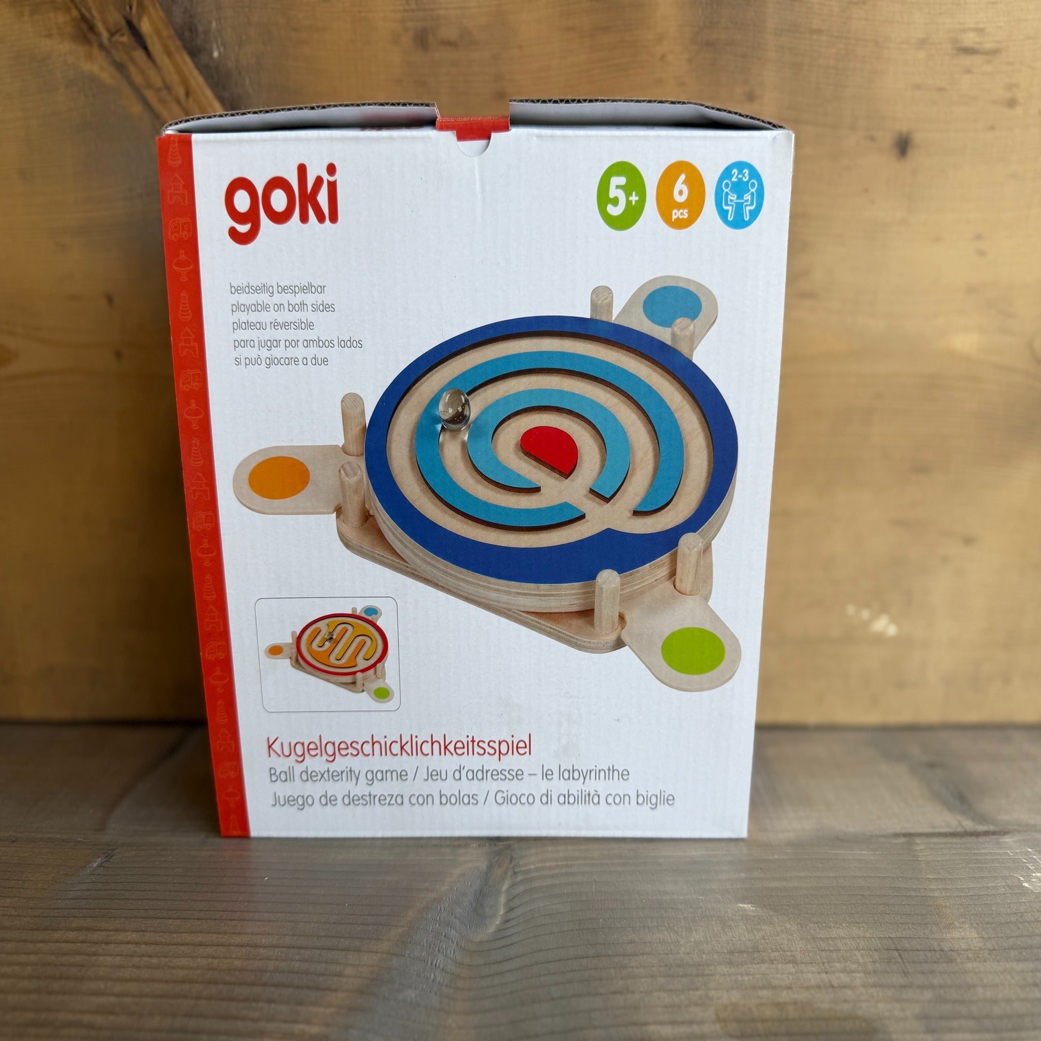 Goki toy packaging on a wooden surface