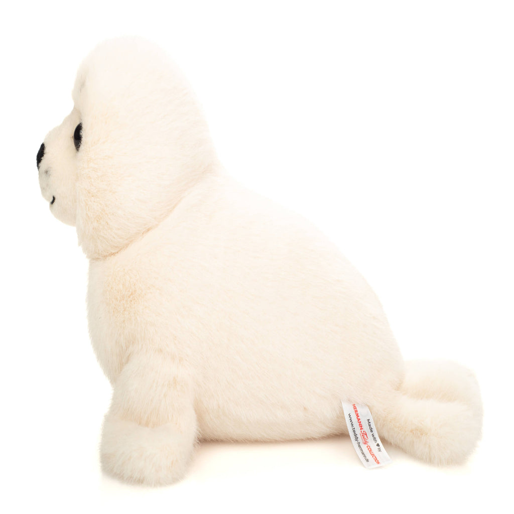 White plush toy seal on a white background
