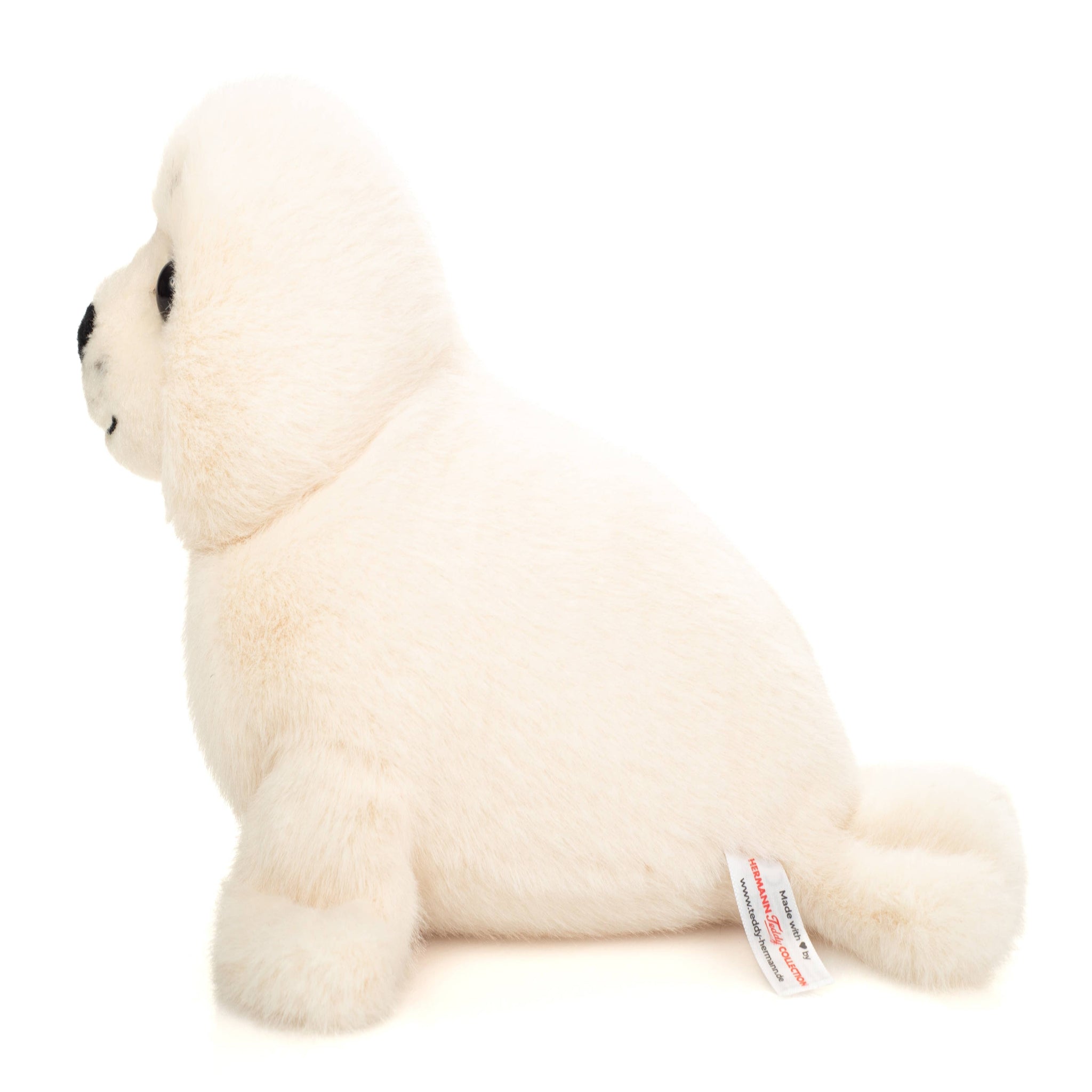 White plush toy seal on a white background