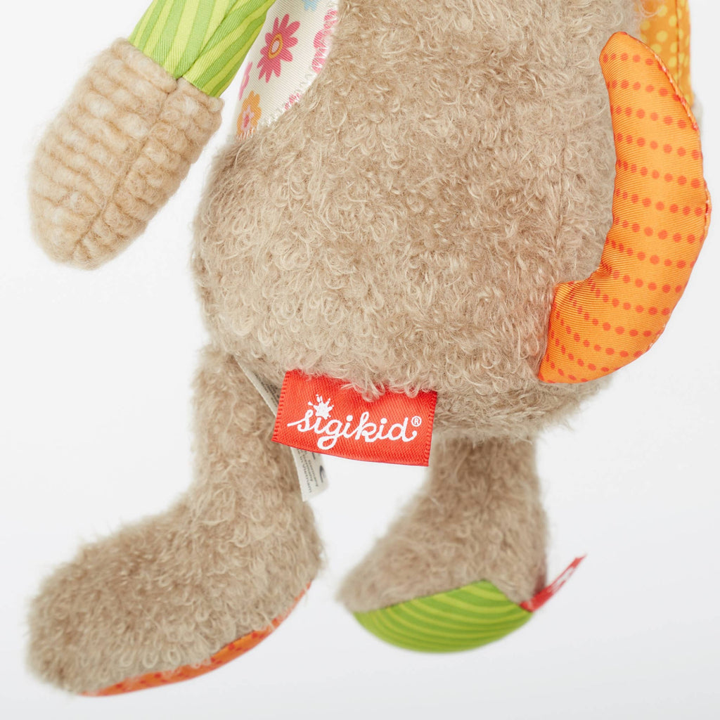 Plush toy with colorful paws and a visible 'igikid' tag on a white background