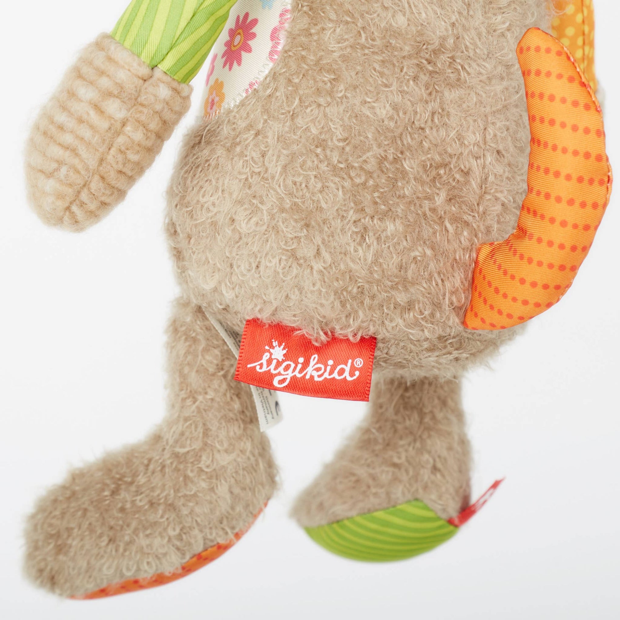 Plush toy with colorful paws and a visible 'igikid' tag on a white background