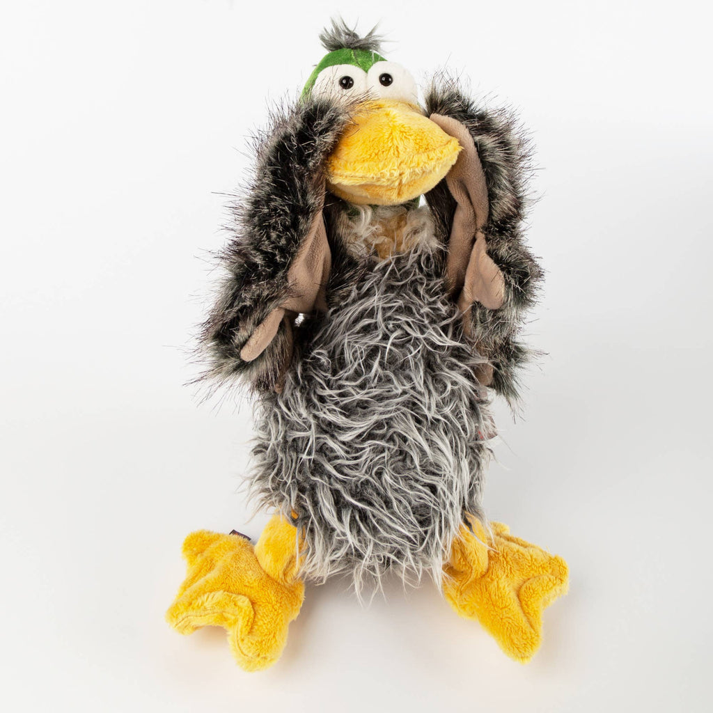 Plush toy resembling a bird with gray feathers, yellow beak, and feet on a white background