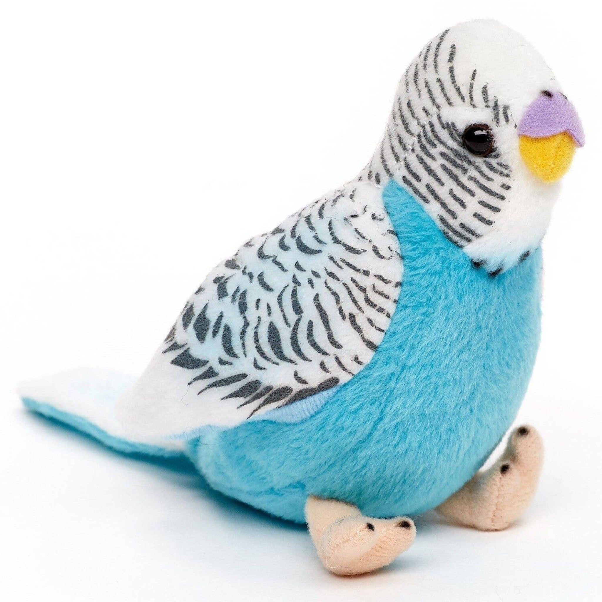 Plush toy parakeet with blue body and white head on a white background