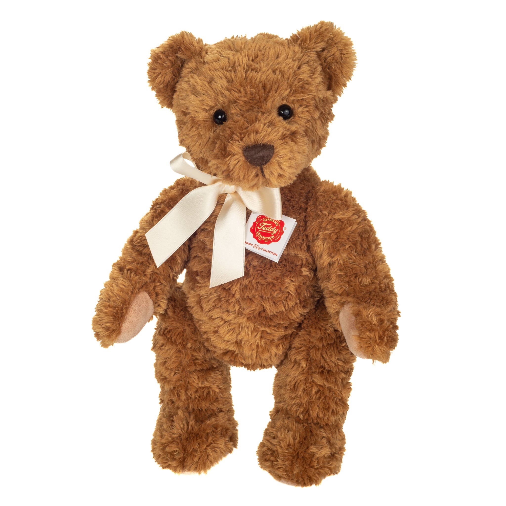 Brown teddy bear with a white ribbon and tag on a white background