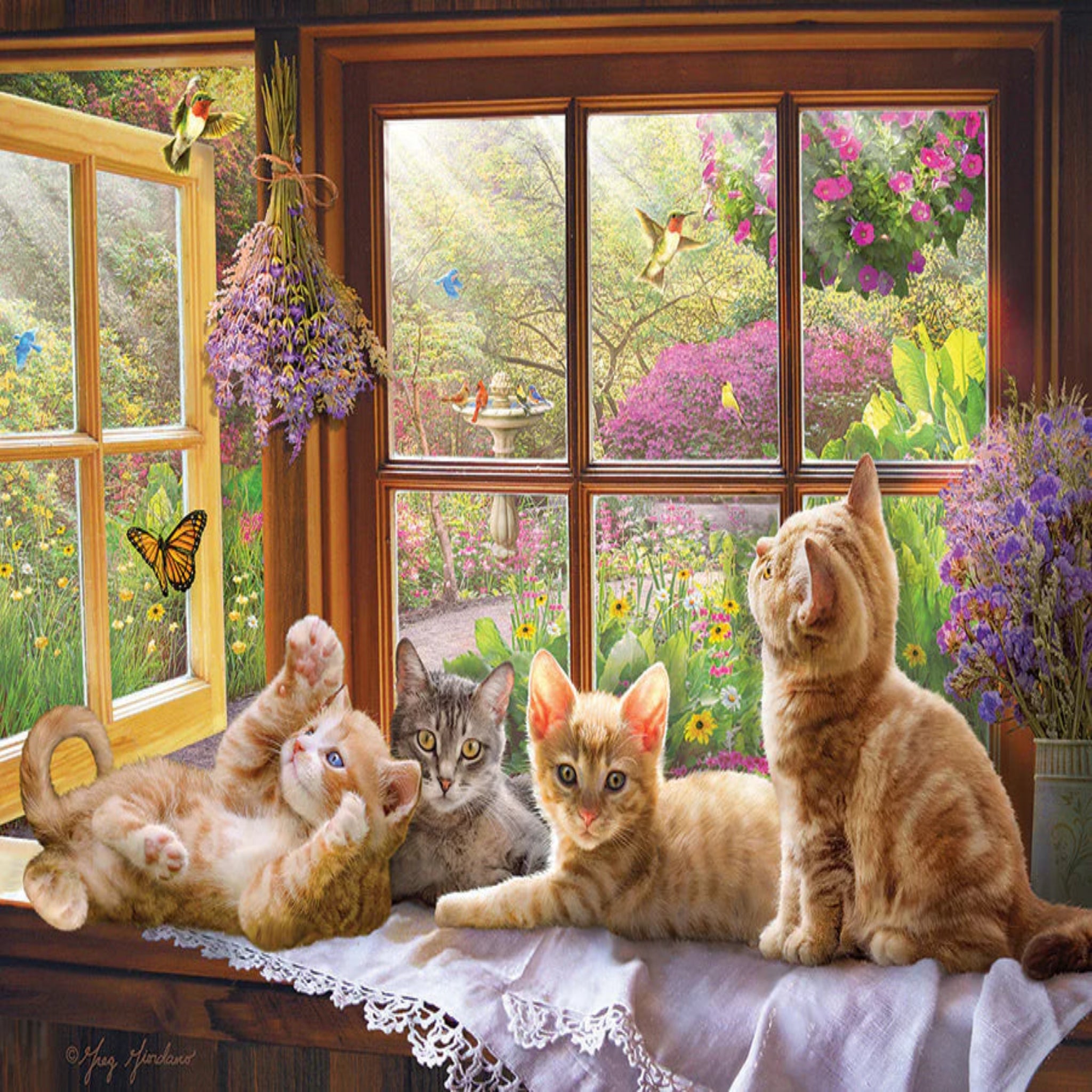 Cats on a windowsill with a view of a garden