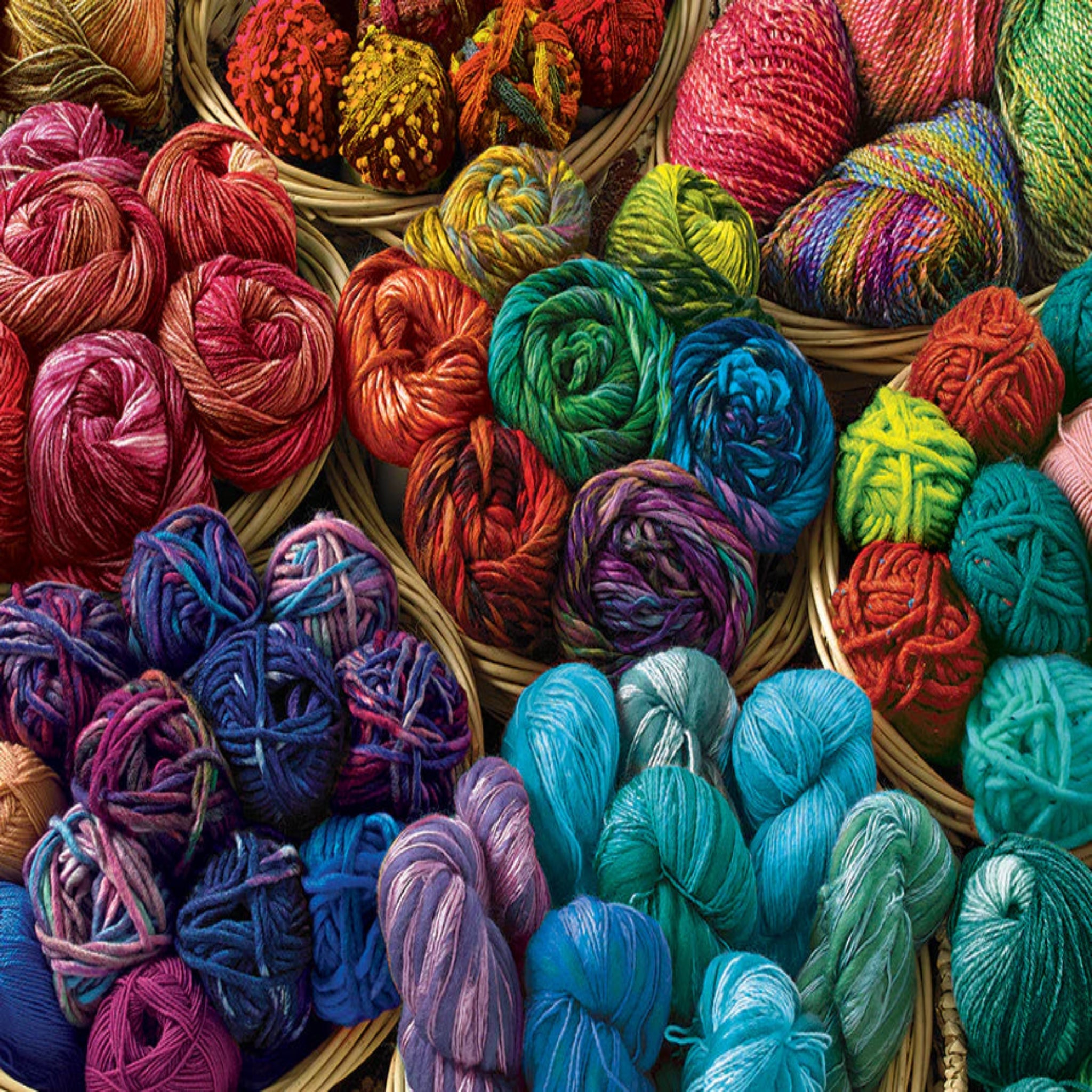 Assorted colorful yarn balls in baskets