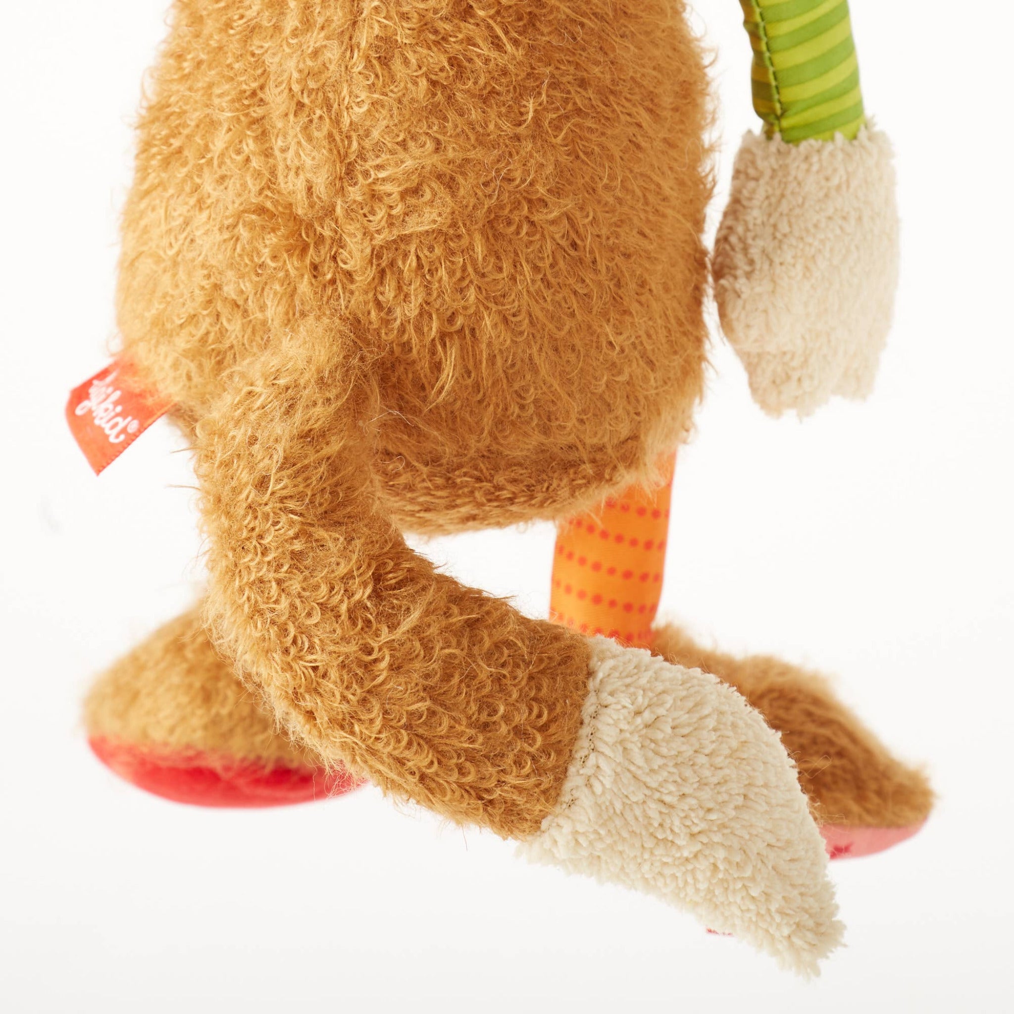Close-up of a plush toy with a focus on the legs and feet.