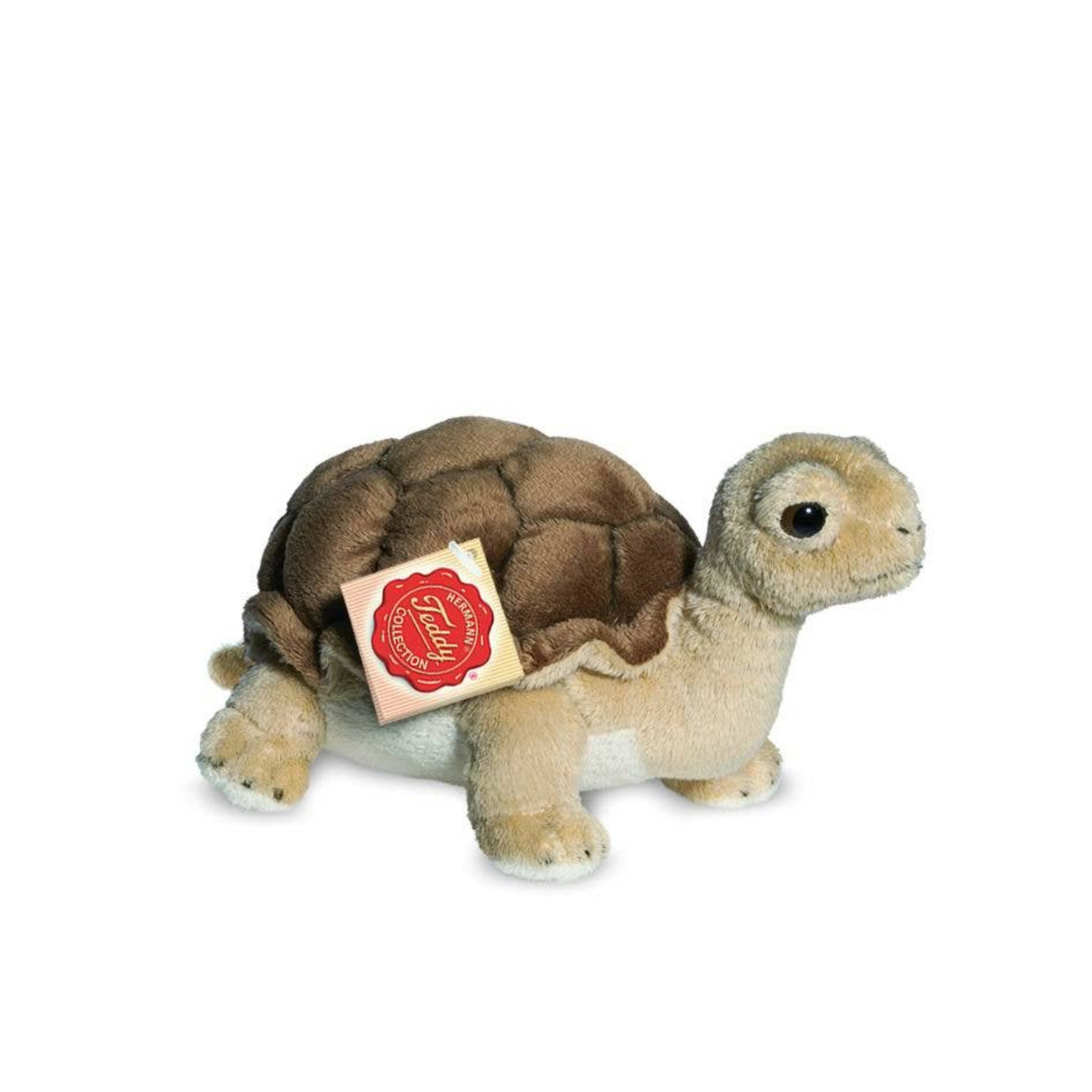 Plush turtle toy with a visible brand label on a white background