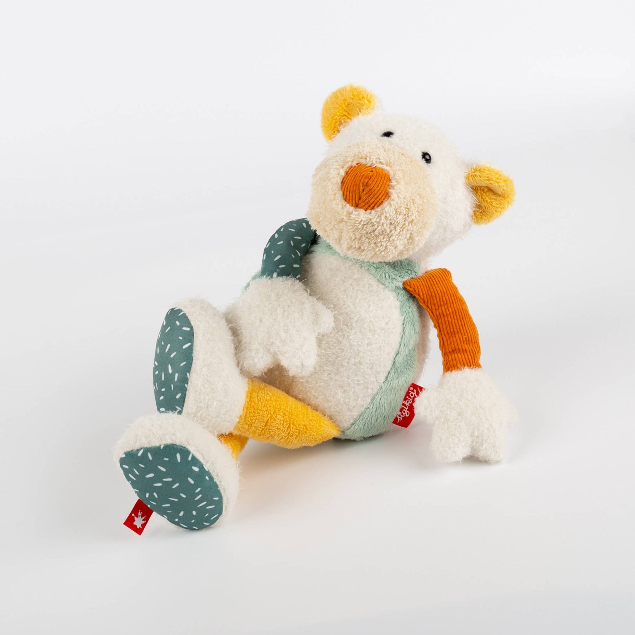 Plush toy with a white face, orange nose, and multicolored body on a light gray background