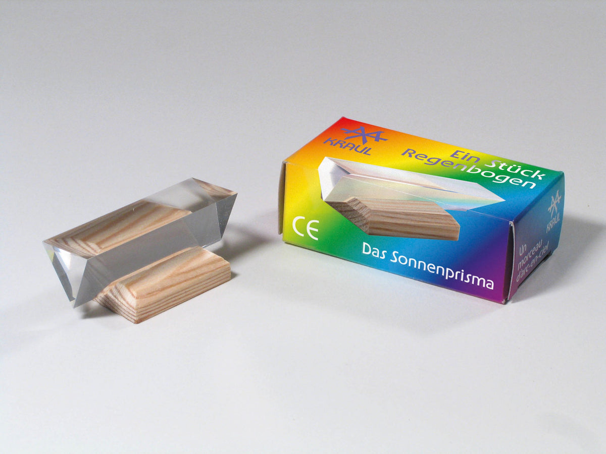 Small acrylic prism by Kraul, beside its rainbow box