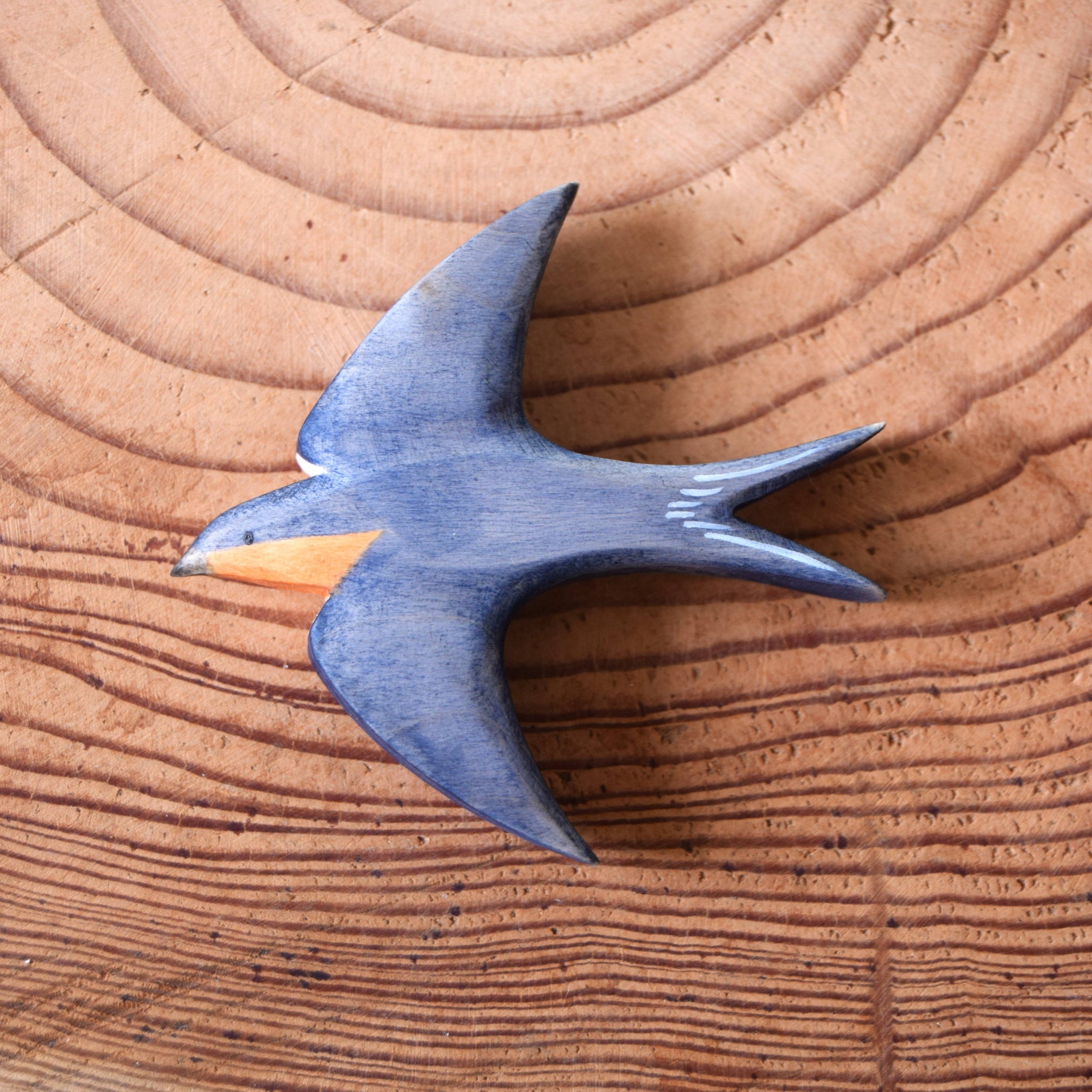 Blue bird figurine on a wooden surface