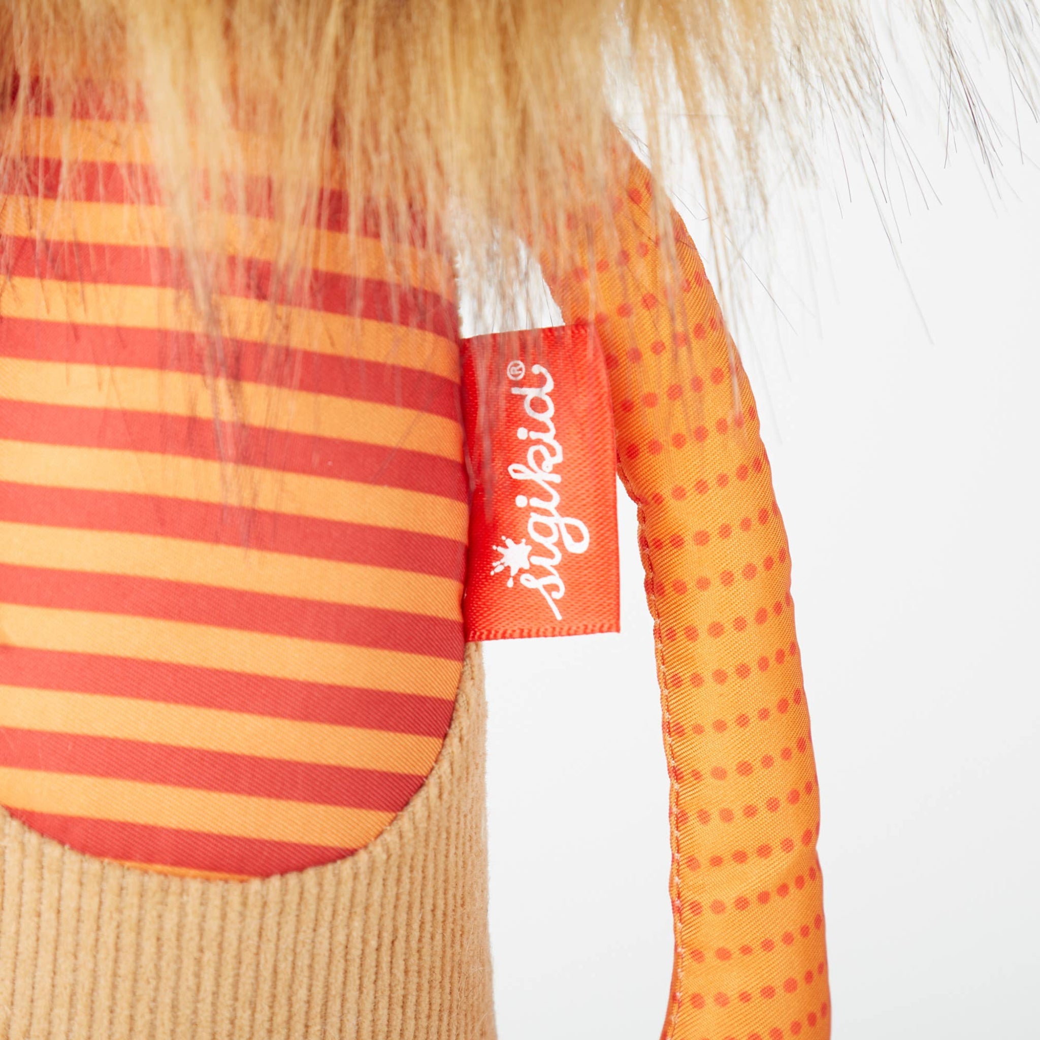 Close-up of a child's outfit with red and yellow stripes and a polka dot pattern, featuring the Sigikid brand label.