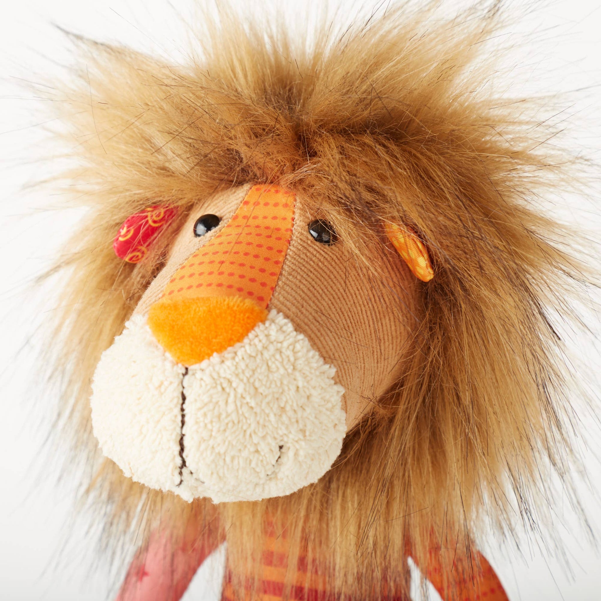 Close-up of a plush lion toy with a white background