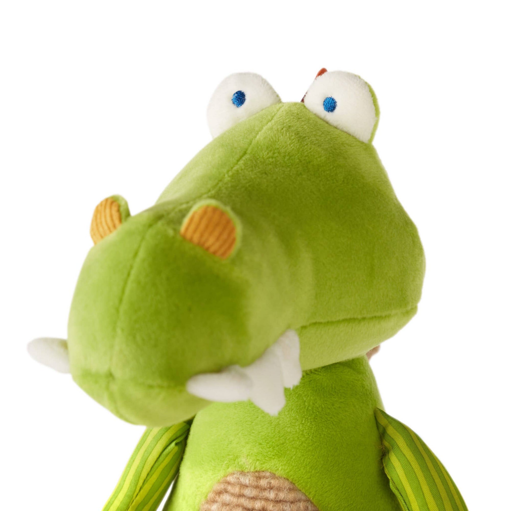 Green plush toy with white accents on a white background