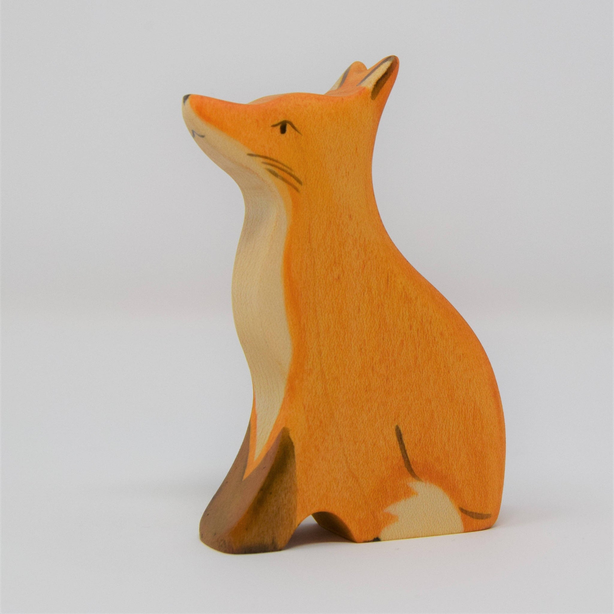 Wooden fox figurine on a white background