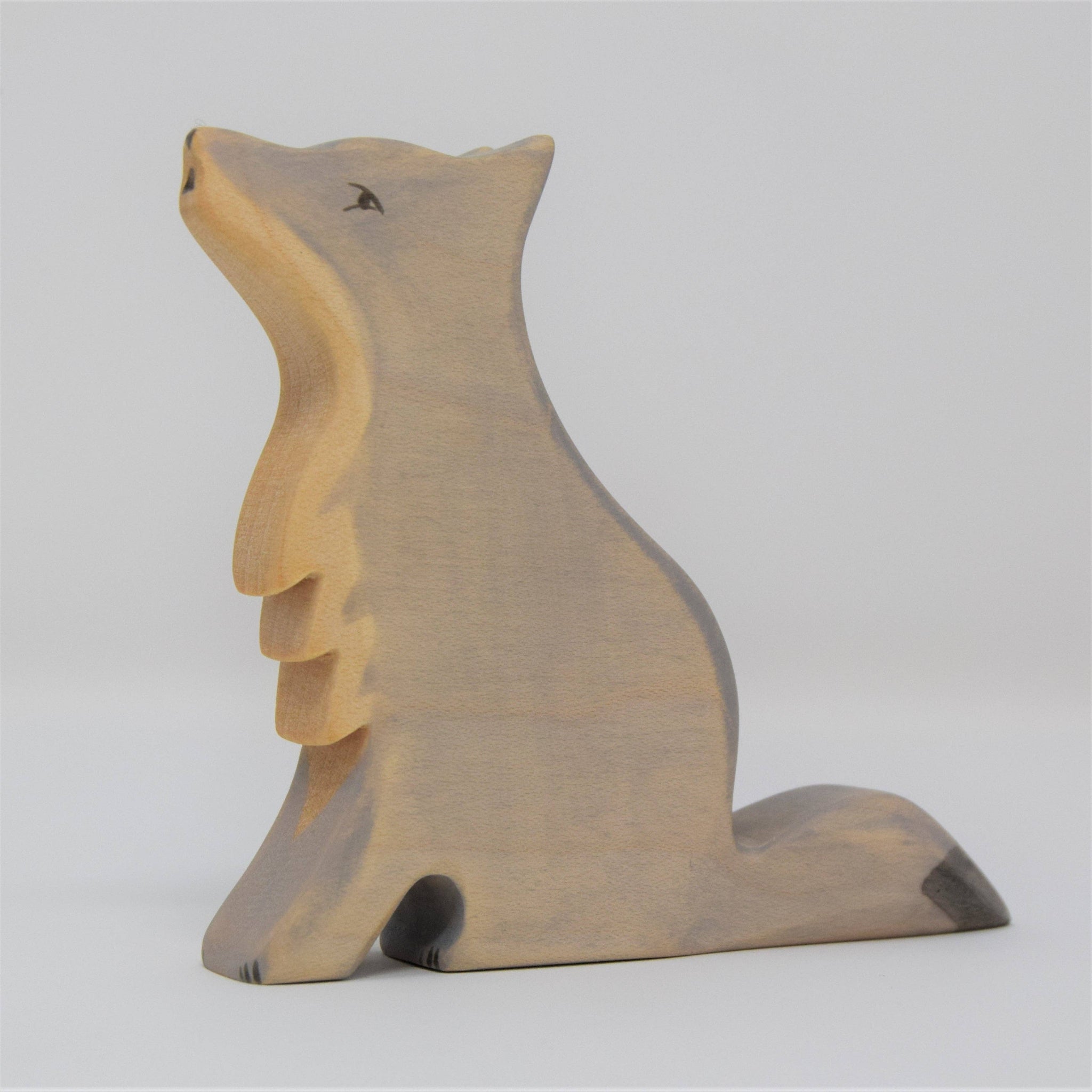 Wooden bear figurine on a light gray background