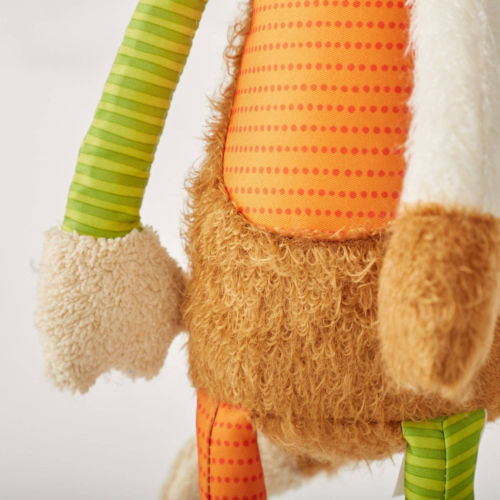 Close-up of a gnome with a beard, wearing an orange hat and green striped pants on a white background.