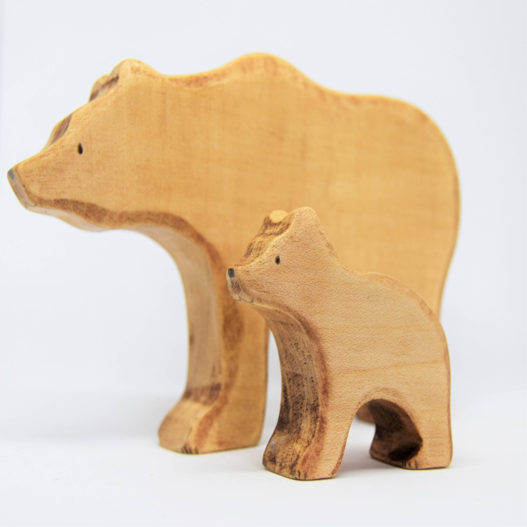 Two wooden bear figures on a white background