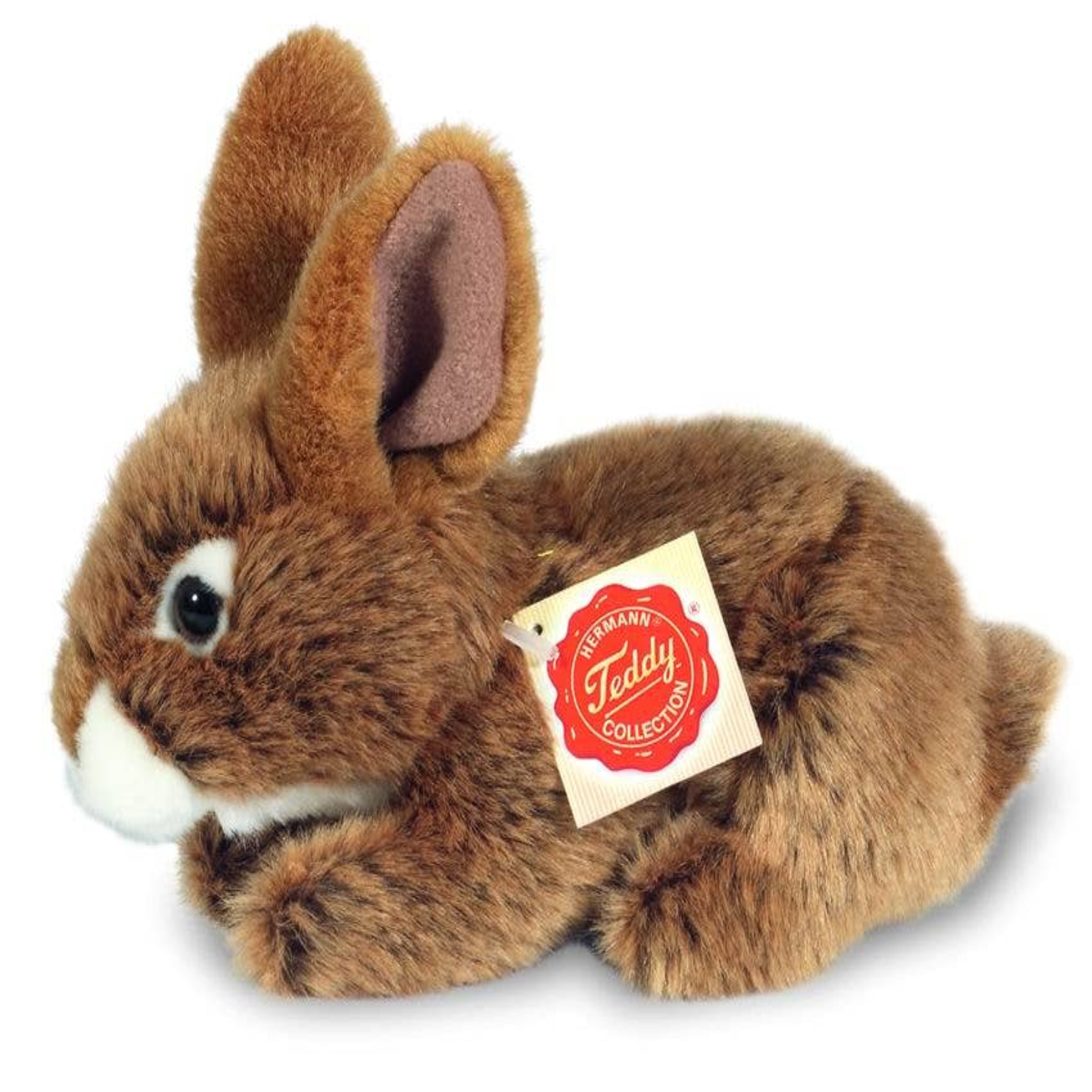 Brown plush bunny toy with a visible tag on a white background