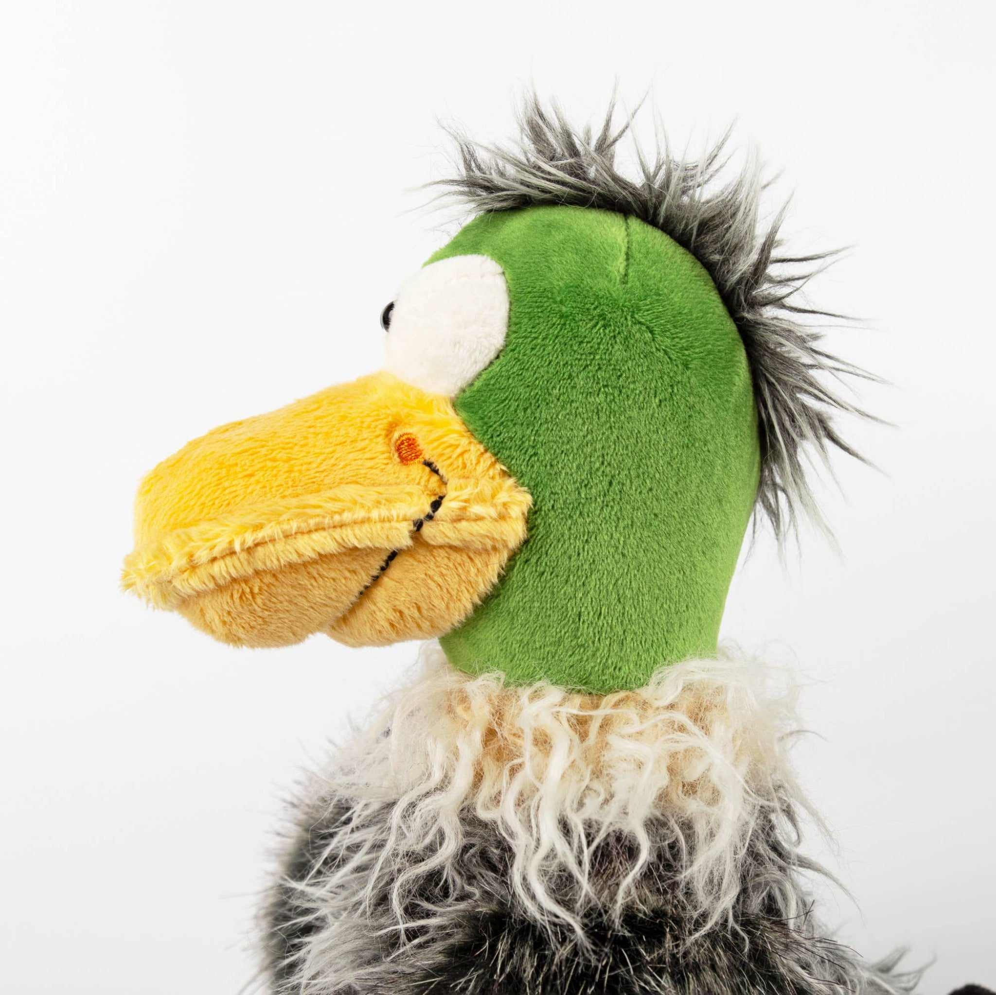 Plush toy resembling a duck with green head and yellow beak on a white background