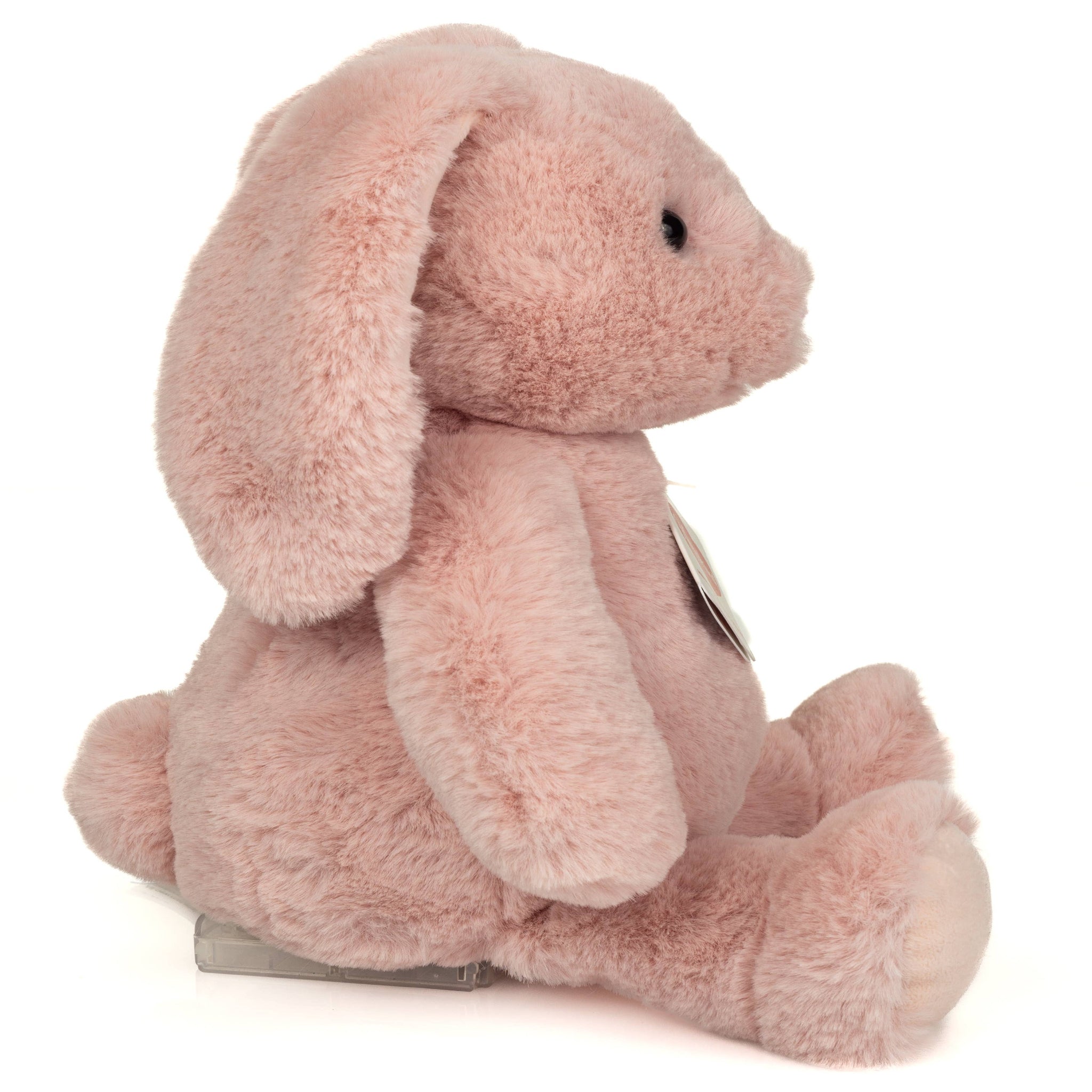 Pink plush bunny toy with a tag on a white background