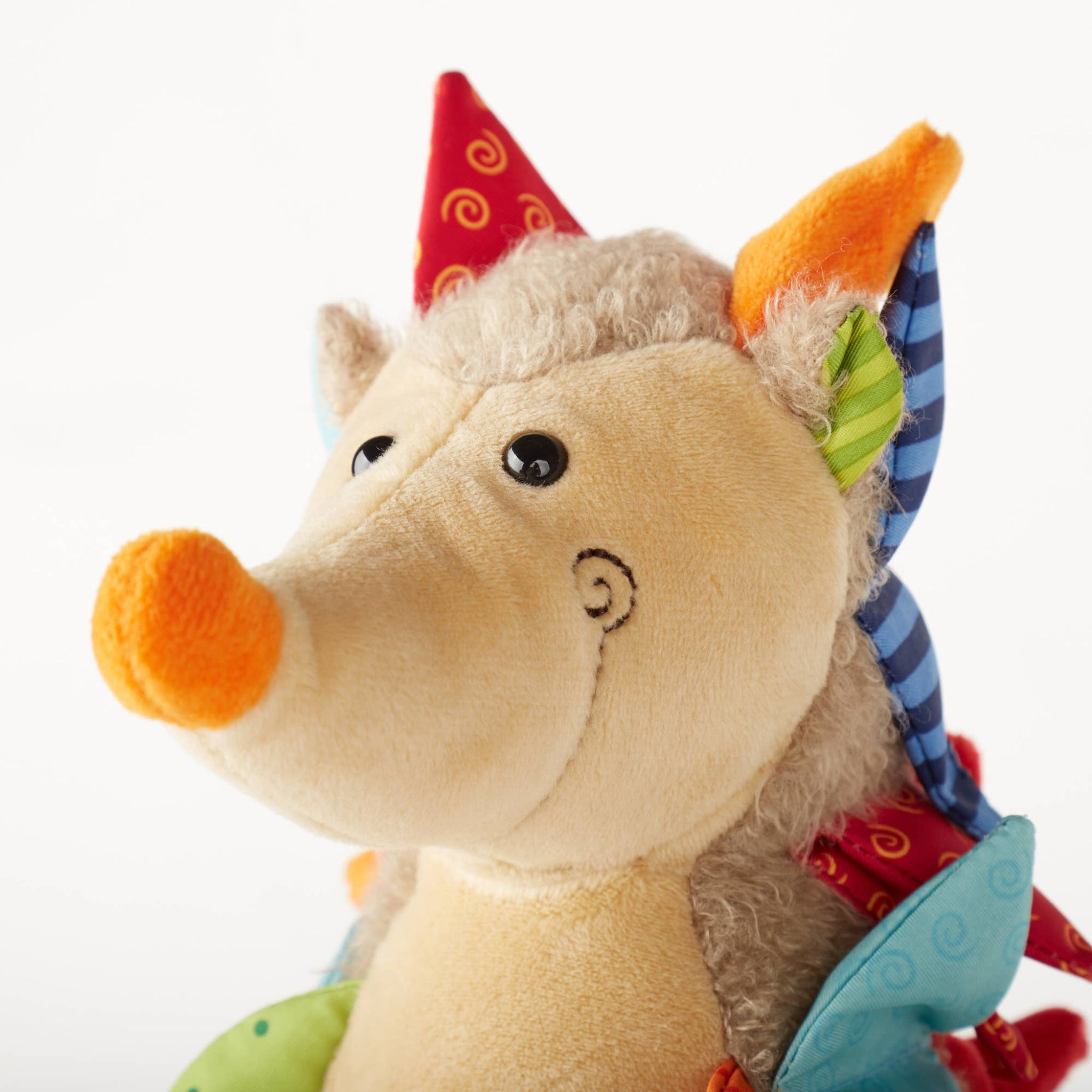 Plush toy dragon with colorful accents on a white background