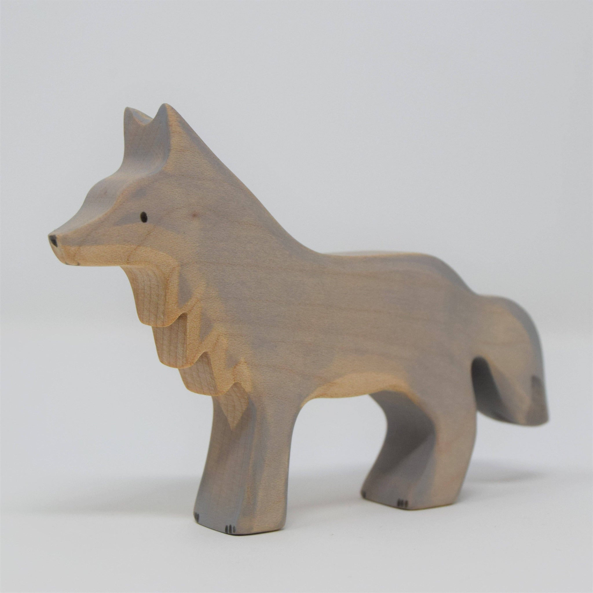 Wooden wolf figurine on a white background