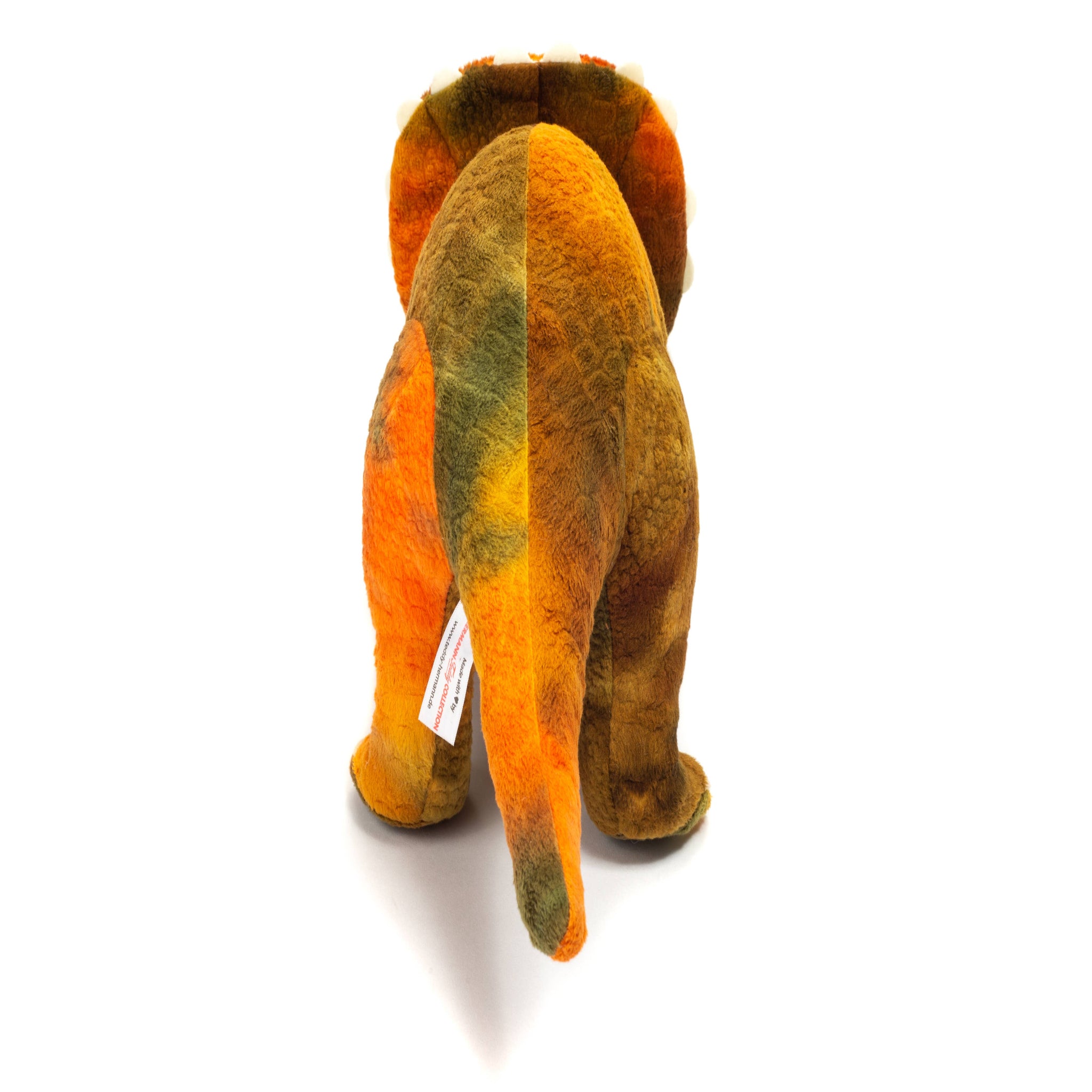 Plush elephant toy with a tag on a white background