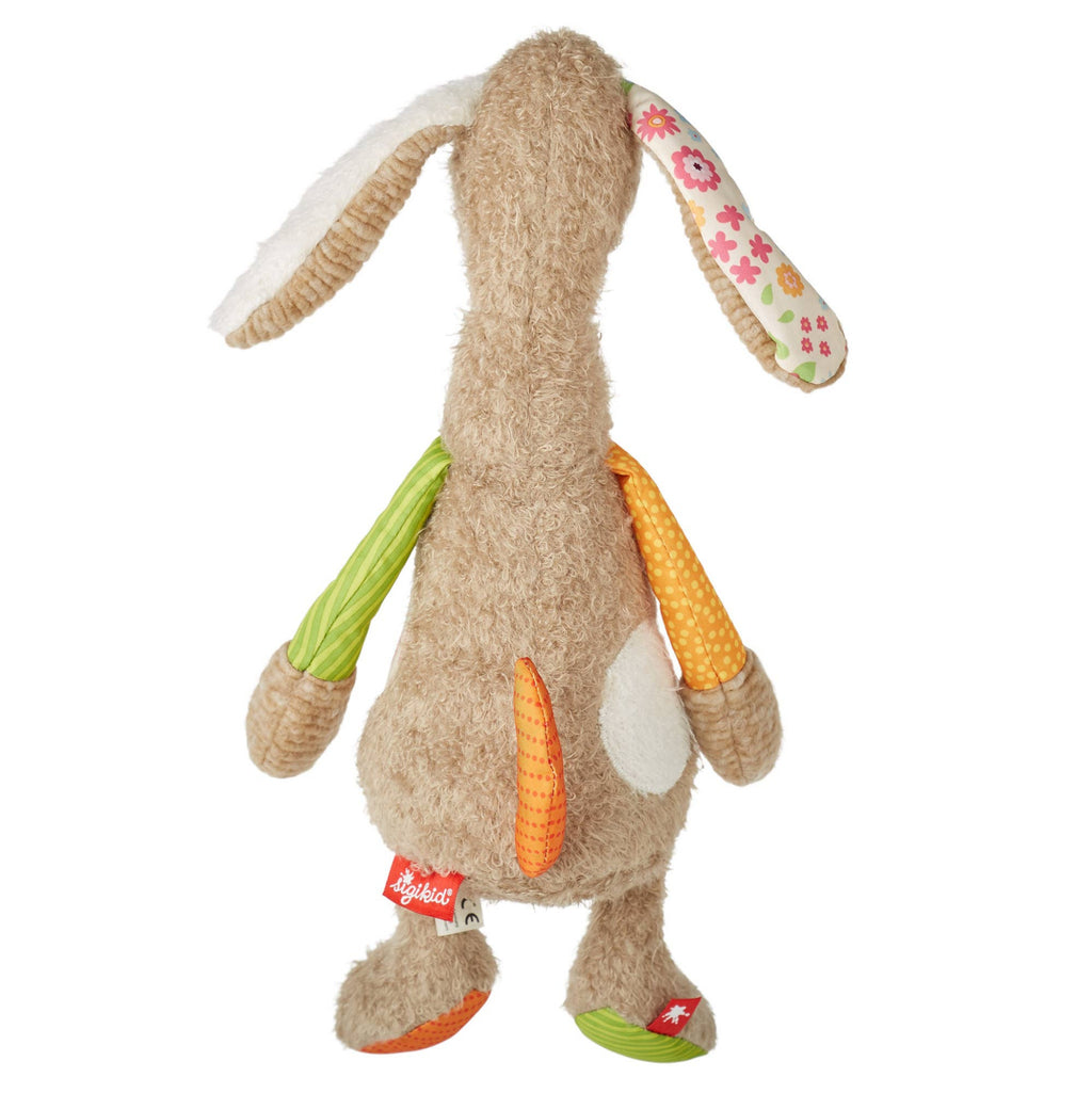 Plush toy rabbit with colorful ears and a tag on a white background