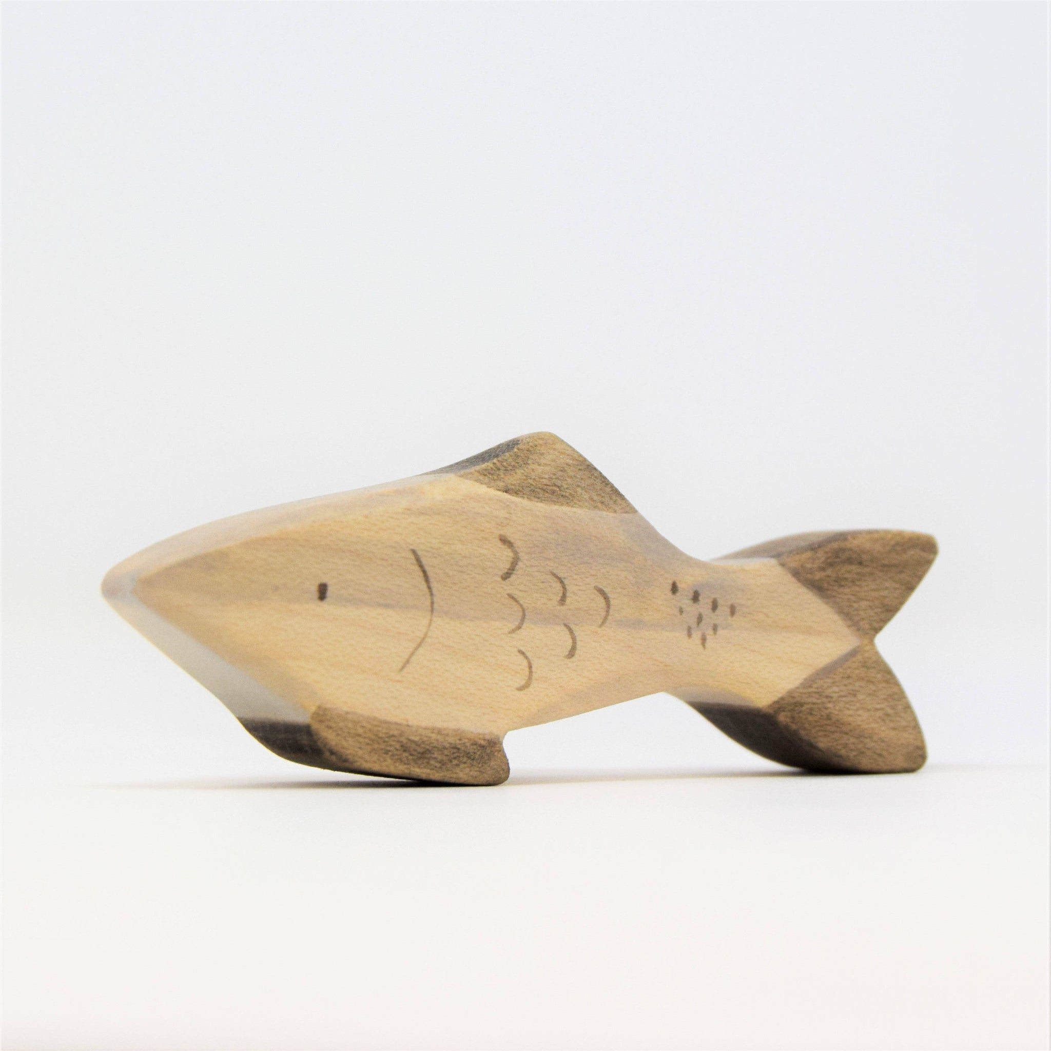 Wooden fish-shaped object on a white background