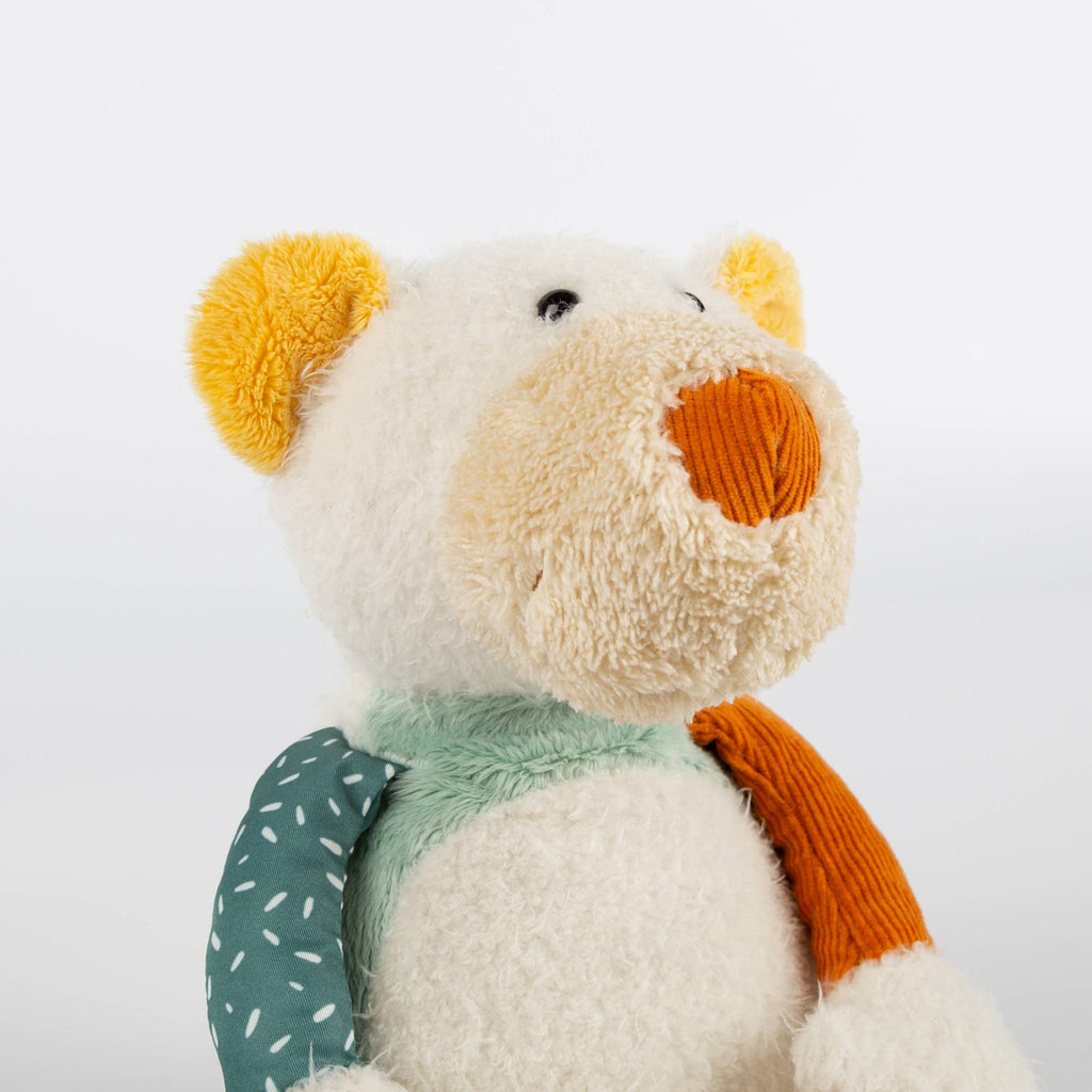 Plush toy with a green bib and orange accents on a white background