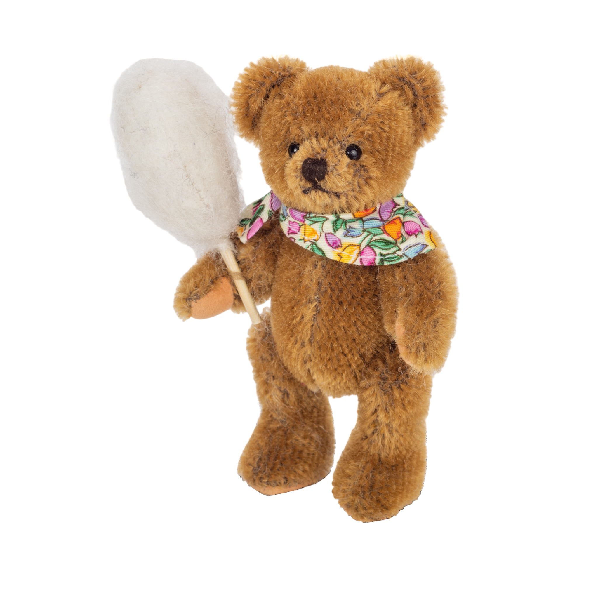 Teddy bear holding a white paddle with a colorful bandana on a white background